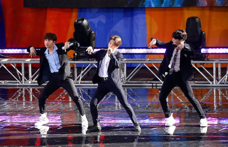 The members of BTS perform onstage