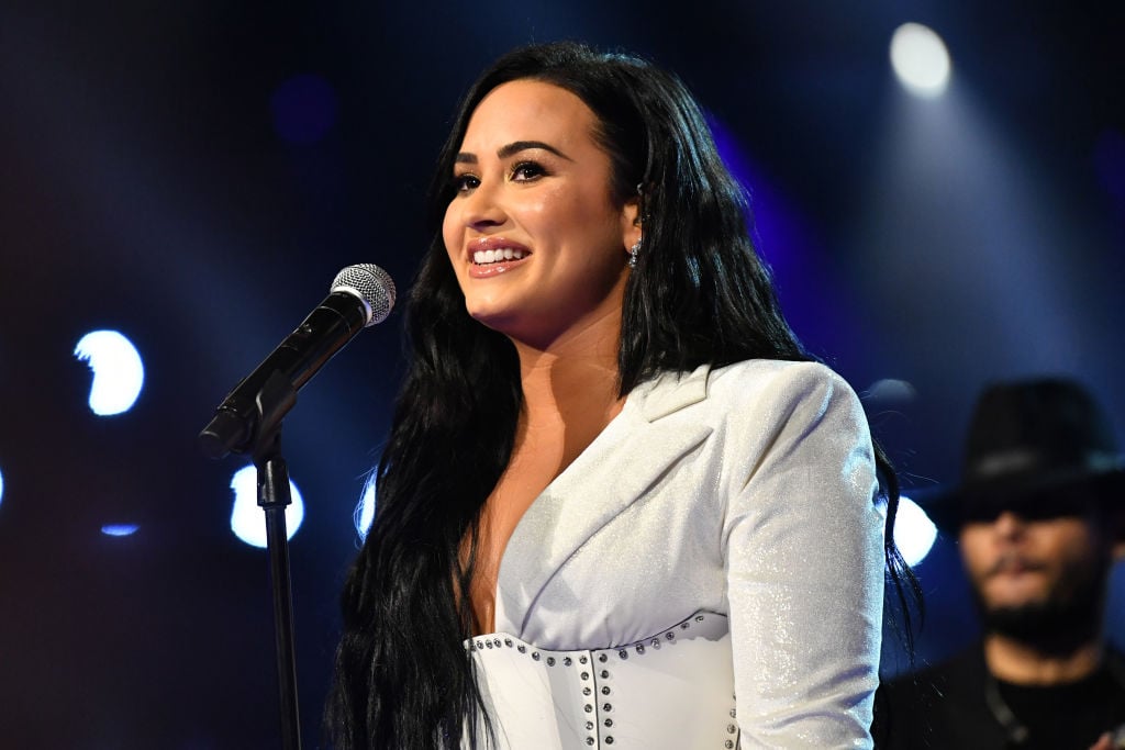 Demi Lovato performs at Grammys 2020 wearing white gown