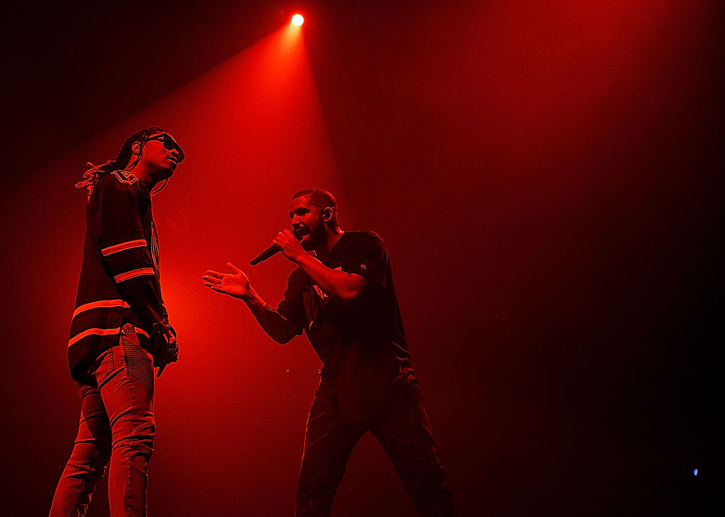 Drake and Future on stage, in shadow under red lighting