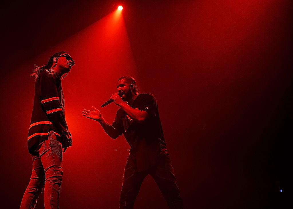 Drake and Future on stage, in shadow under red lighting