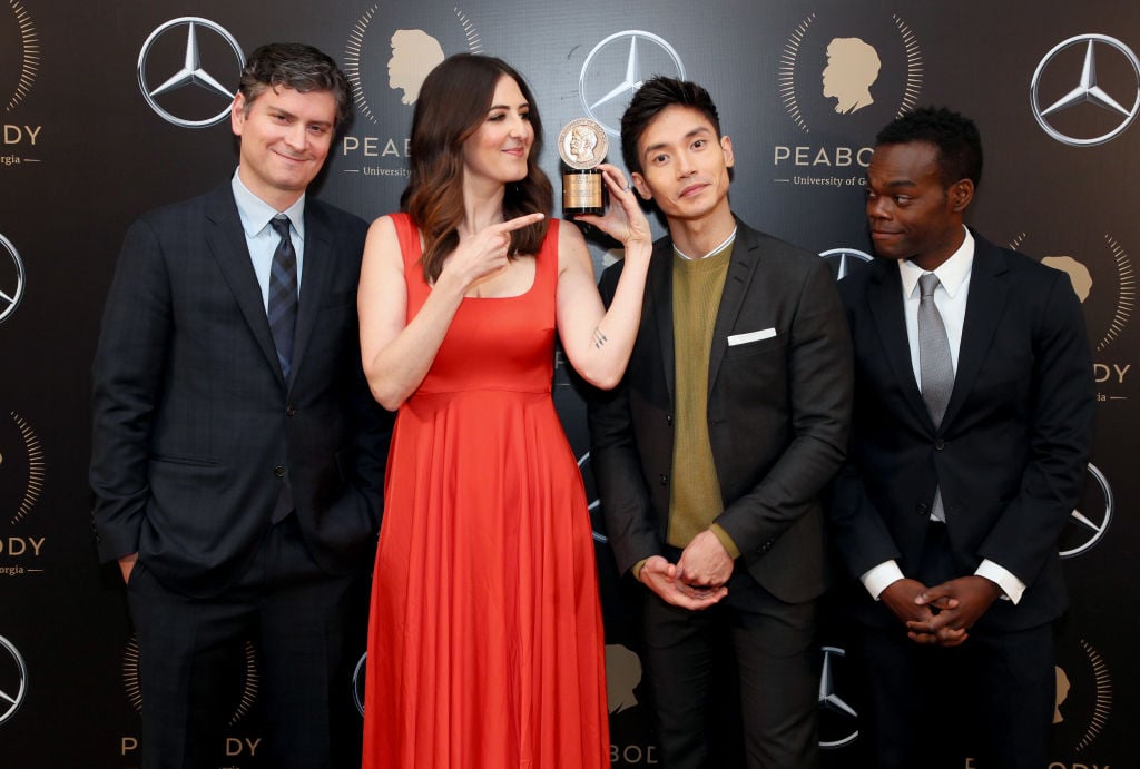 Michael Schur, D'Arcy Carden, Manny Jacinto, and William Jackson Harper pose with the Peabody Award for The Good Place.