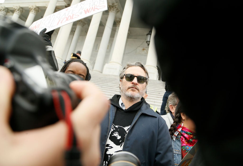 Joaquin Phoenix stands with protestors on the steps of the U.S. Capitol Building