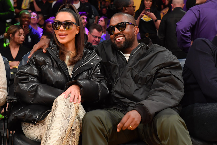 Kim Kardashian and Kanye West attend a basketball game