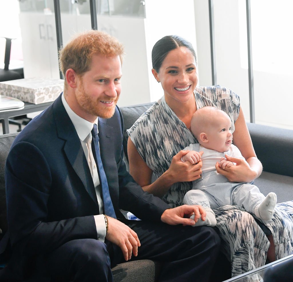 Prince Harry and Meghan Markle sit with baby Archie in Africa