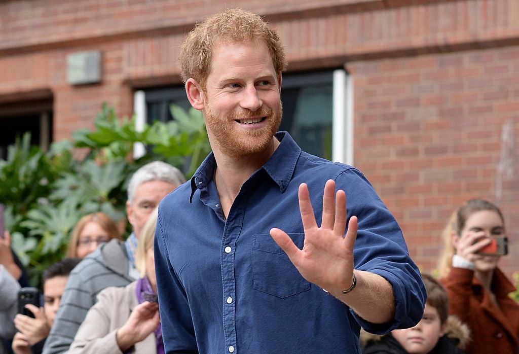 Prince Harry waves as he leaves Nottingham's new Central Police Station.