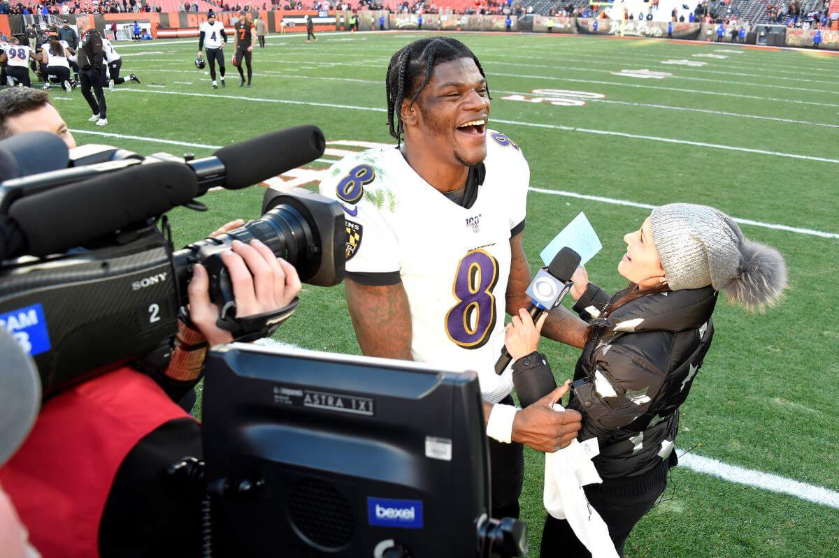 Quarterback Lamar Jackson #8 of the Baltimore Ravens laughs during a post game interview