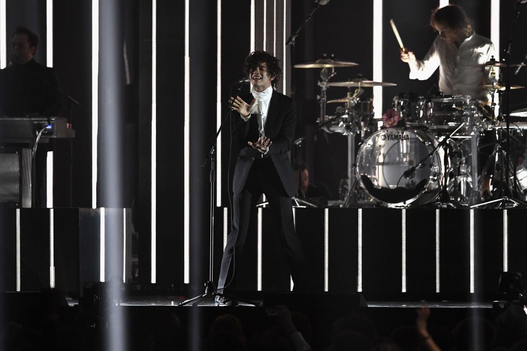 Matthew Healy performs with The 1975 on stage at The BRIT Awards 2017 