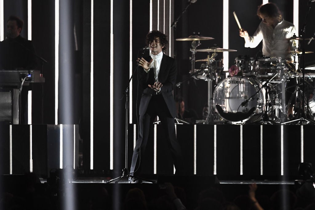 Matthew Healy performs with The 1975 on stage at The BRIT Awards 2017