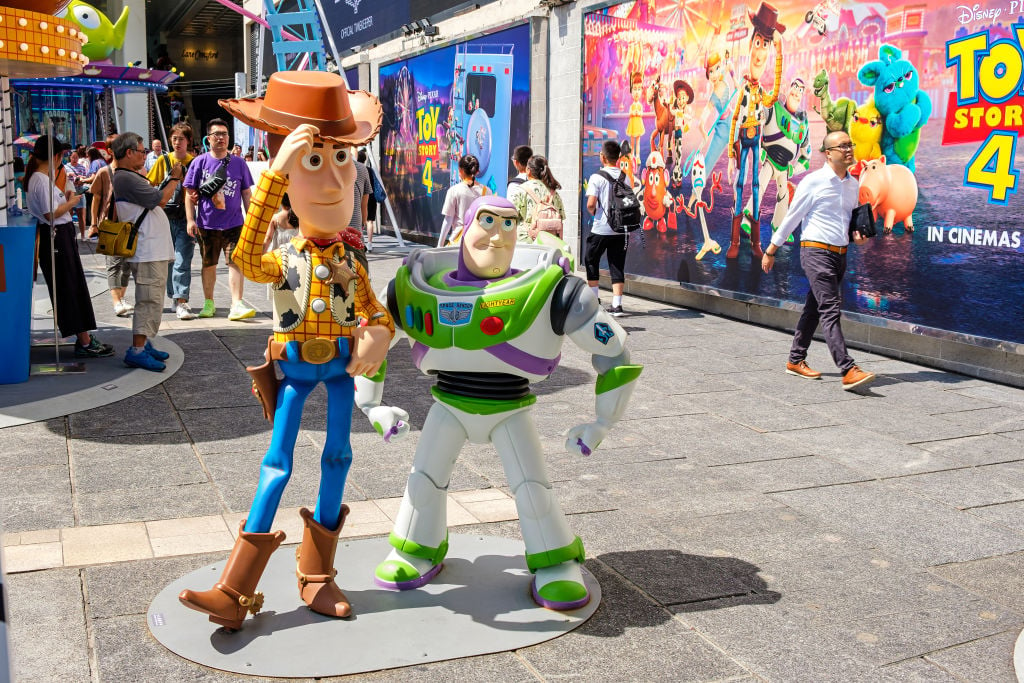 Replicas of Sheriff Woody and Buzz Lightyear at a carnival