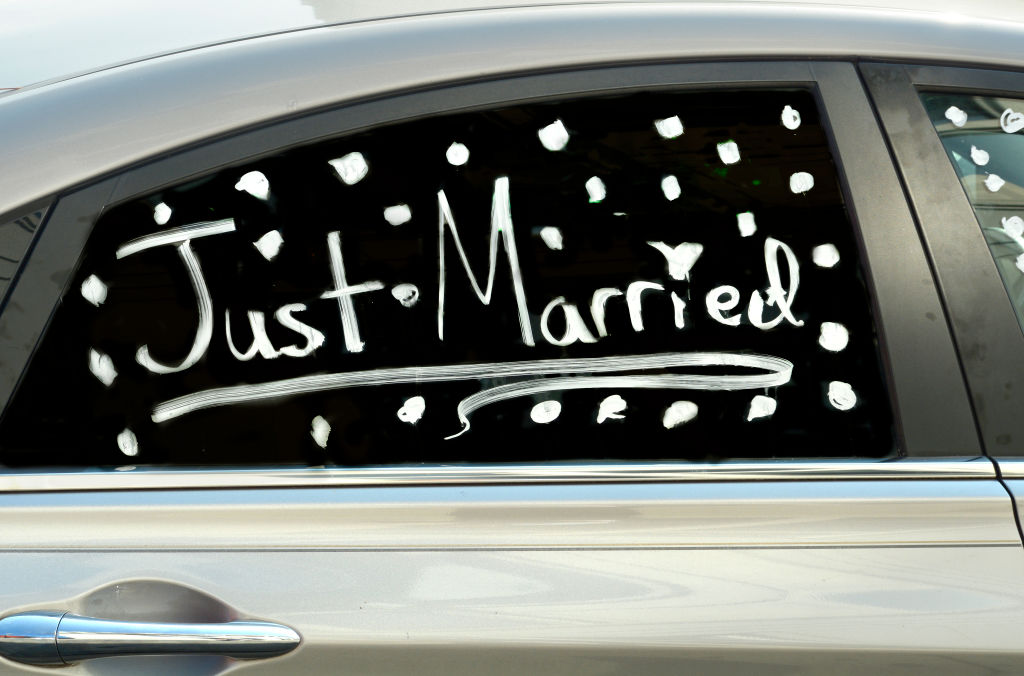 Just Married written on car window 