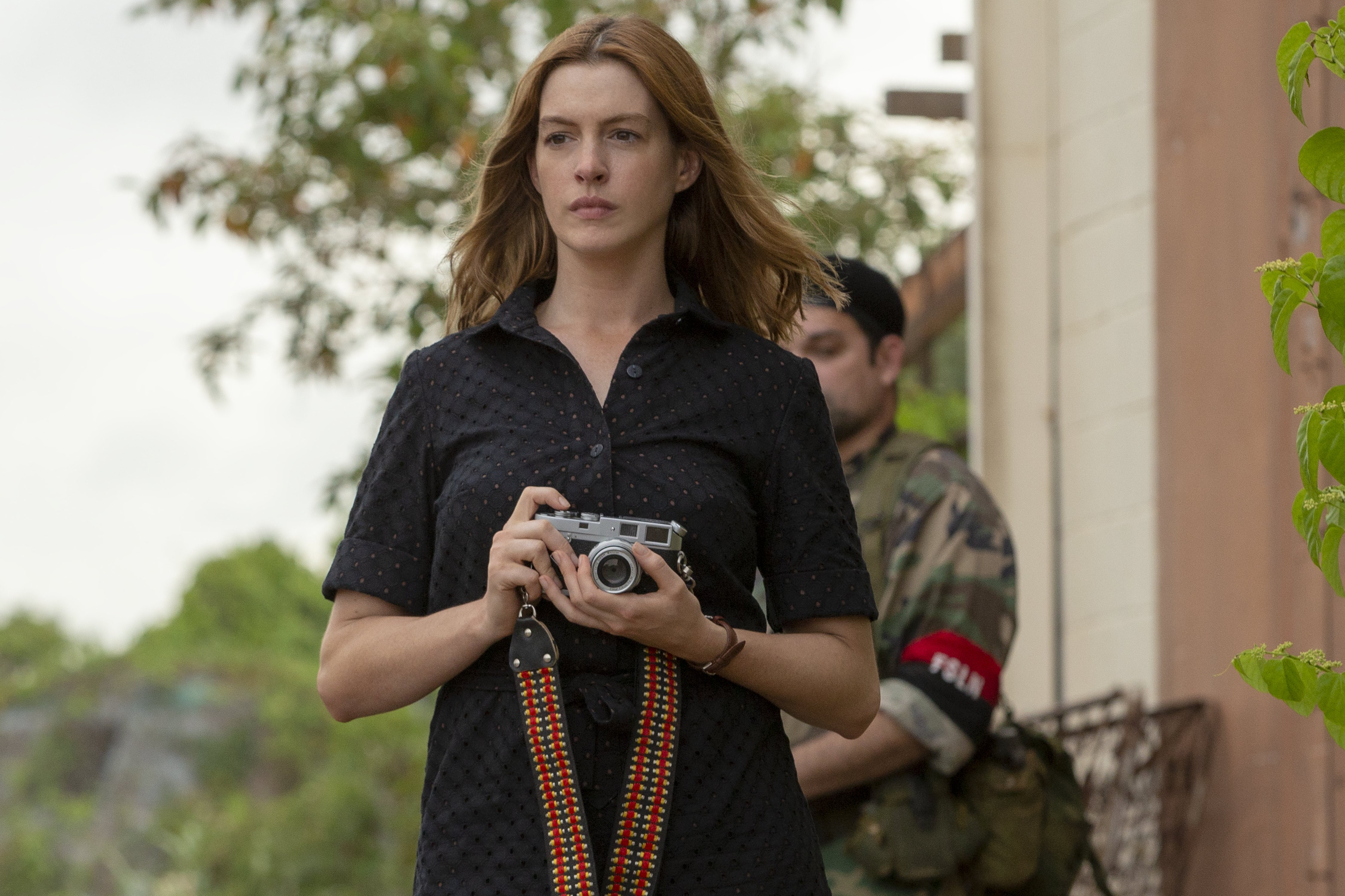 Anne Hathaway holding a camera