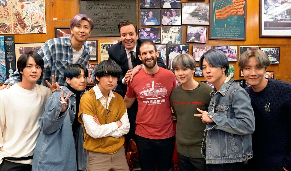 RM, host Jimmy Fallon, (bottom row l-r) Jin, Jungkook, V, a Katz Deli employee, SUGA, Jimin, and J-Hope of BTS on February 24, 2020