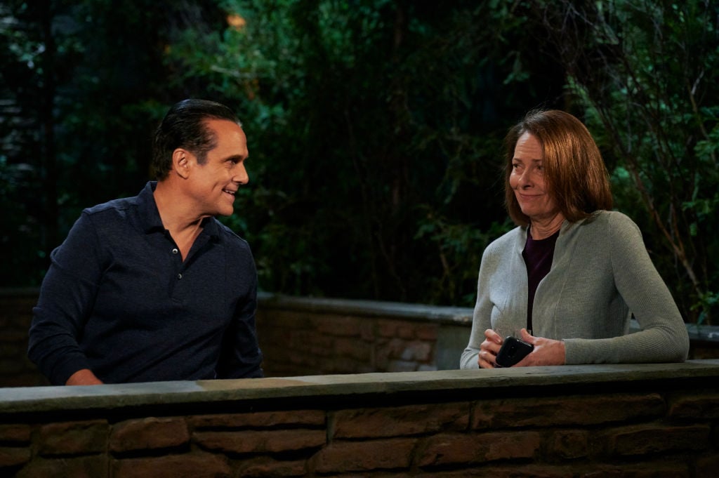 Maurice Benard and Bonnie Burroughs on set of 'General Hospital' having a conversation in front of greenery