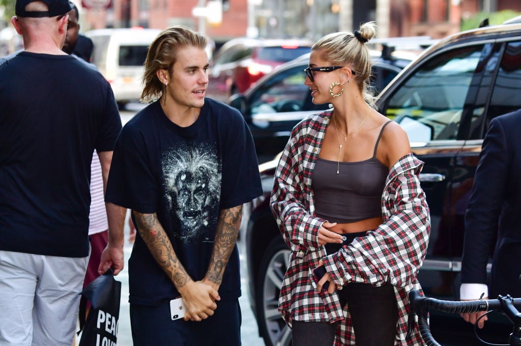 Justin Bieber and Hailey Bieber walking on a street