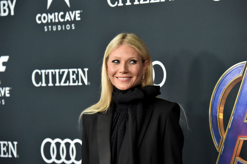 Gwyneth Paltrow looking off to the side, smiling, wearing all black