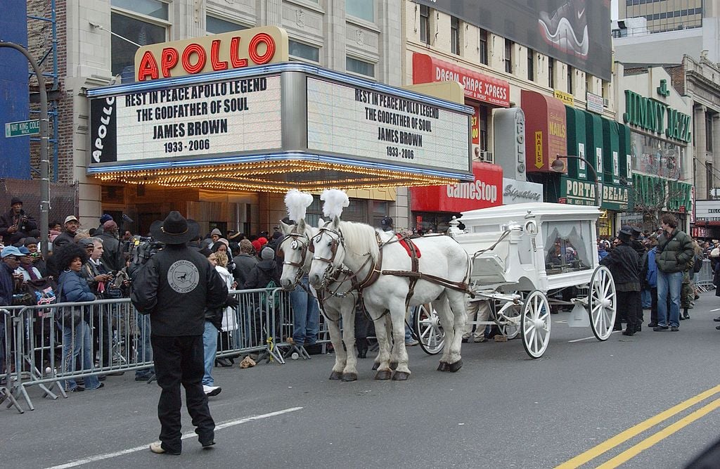 A horse-drawn carriage carrying the casket of James Brown