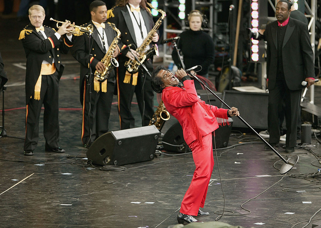 James Brown performs on stage at the Olympic Torch Concert held in The Mall on June 26, 2004 in London