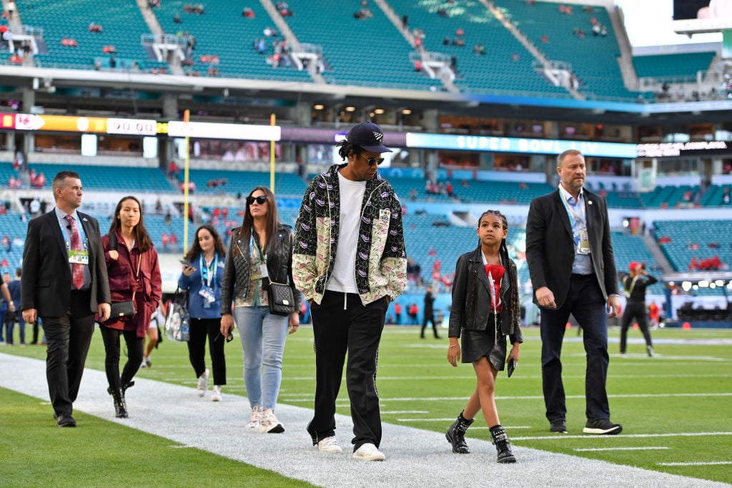 Jay-Z walks with his daughter Blue Ivy Carter as they tour the field before the start of Super Bowl LIV