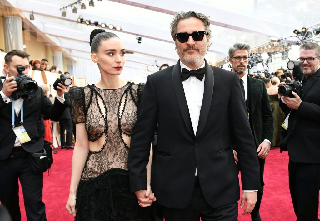 Rooney Mara (left) holding hands with Joaquin Phoenix (right)