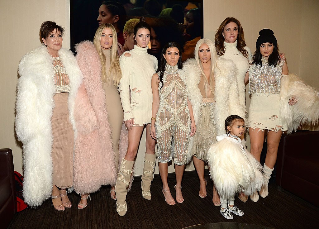 Kardashian-Jennifer family, dressed in glittering cream and white clothing