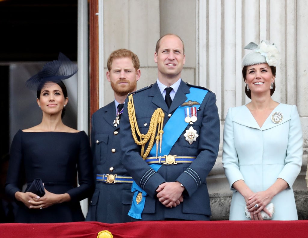 Meghan Markle, Prince Harry, Prince William, and Kate Middleton watch the RAF flypast on the balcony of Buckingham Palace