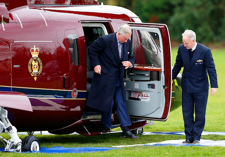 Prince Charles exits a helicopter