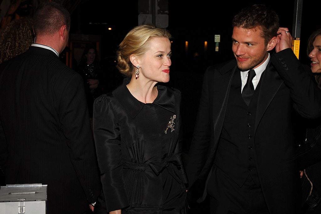Reese Witherspoon, looking off camera, and Ryan Phillipe, wearing all black