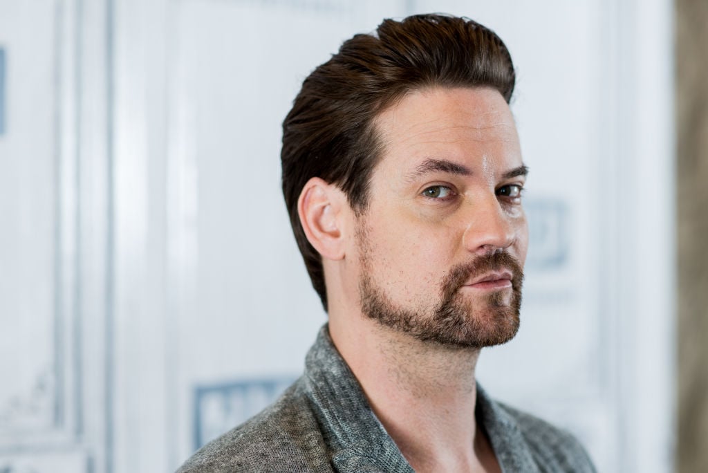 Shane West looking at the camera, body turned slightly away