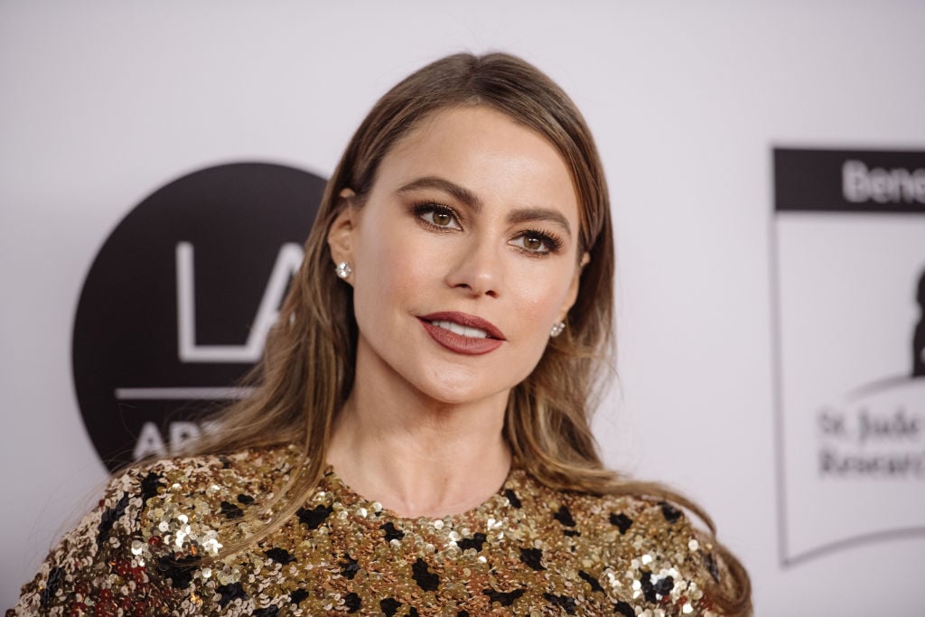 Sofia Vergara in front of a repeating backdrop