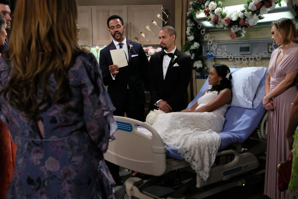Neil Winters (Kristoff St. John) and others gather for Devon Hamilton (Bryton James) and Hilary Curtis' (Mishael Morgan) wedding on The Young and the Restless. 