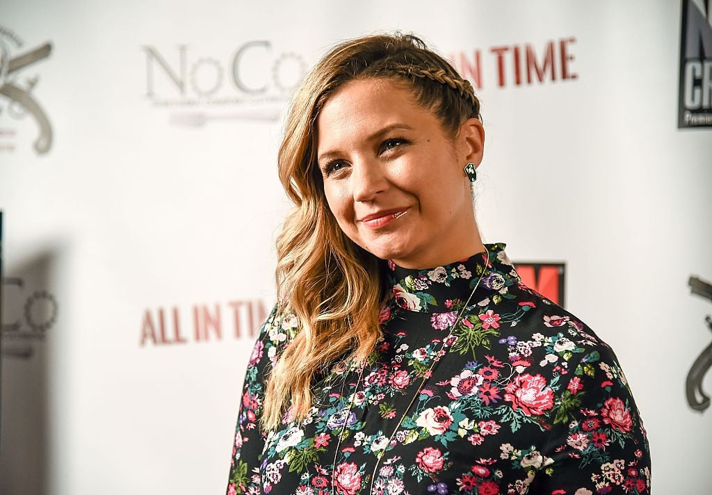 Vanessa Ray smiling in a floral top