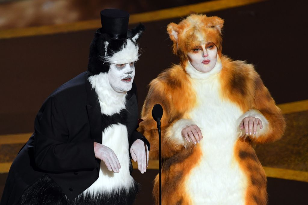 (L-R) James Corden and Rebel Wilson speak onstage during the 92nd Annual Academy Awards