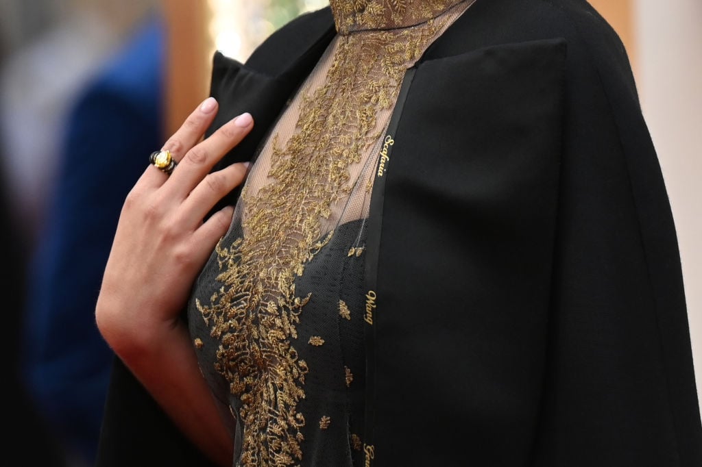 Natalie Portman shows off her cape with the names of female film directors who were not nominated for Oscars at the 92nd Oscars on February 9, 2020.