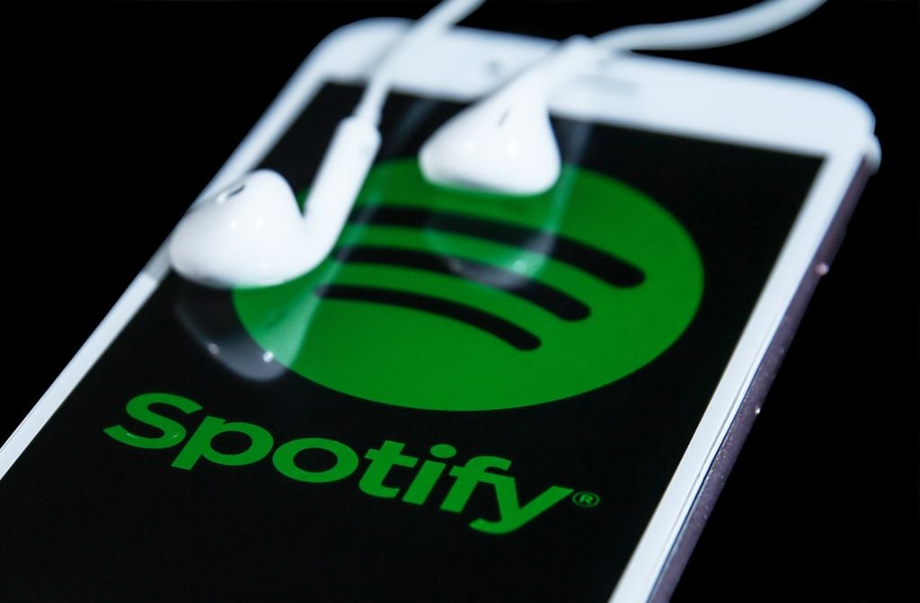 Spotify app on a smartphone with headphones