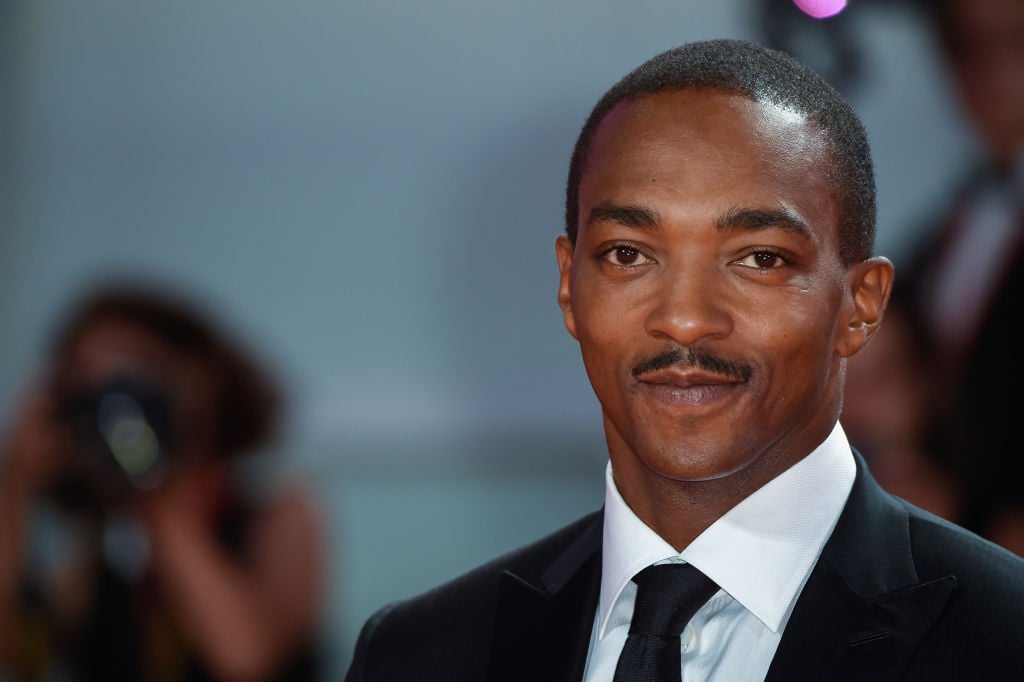 Anthony Mackie in a suit smiling at the camera