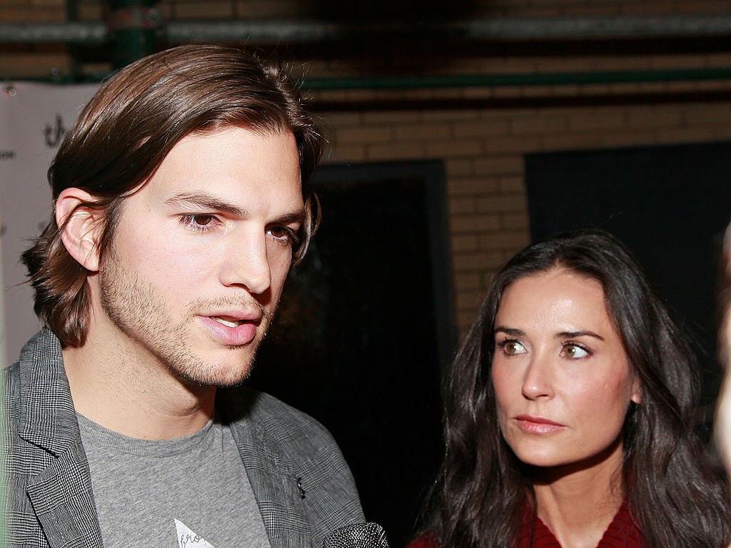 Ashton Kutcher talking and Demi Moore looking at Kutcher