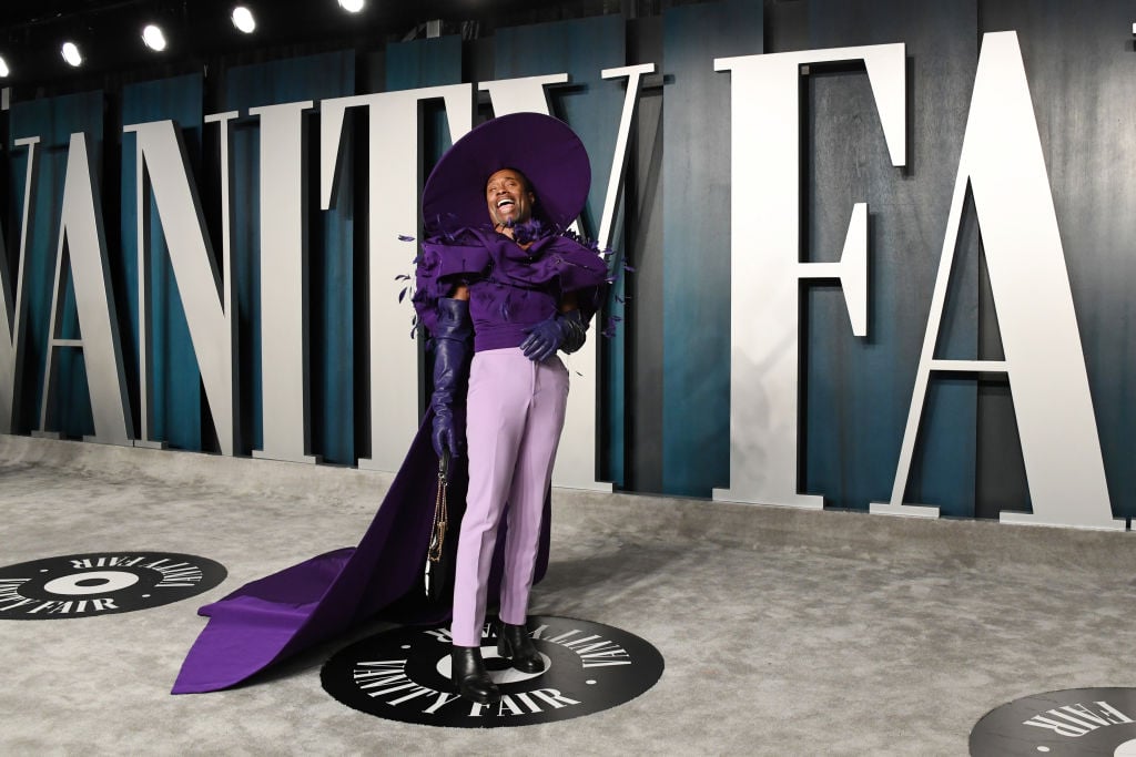 Billy Porter in an all purple outfit laughing