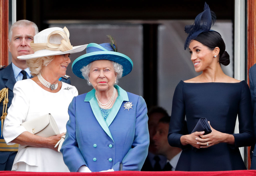 Camilla Parker Bowles and Meghan Markle stand behind Queen Elizabeth II at the Centenary of the RAF on July 10, 2018