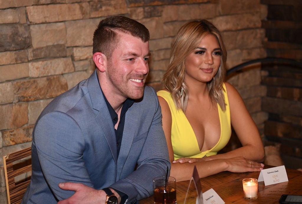 Damian Powers looking off camera with Giannina Gibelli