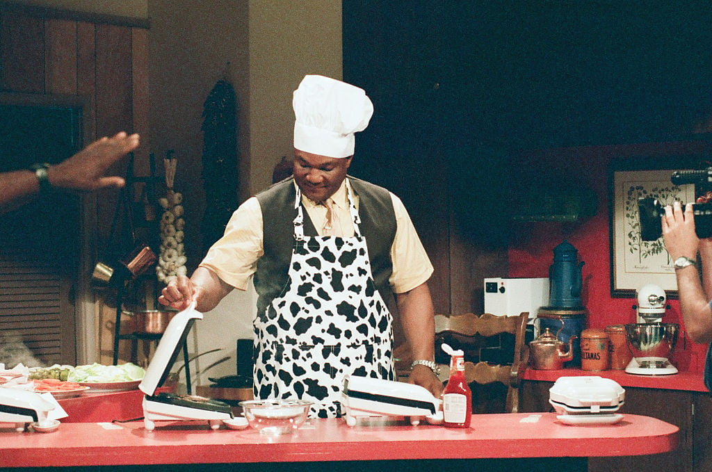 George Foreman looking down at George Foreman grills