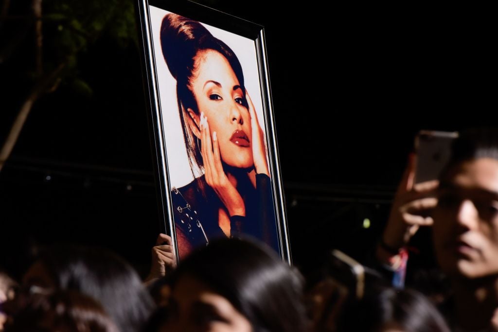 Fans holding a photo of Selena Quintanilla at Hollywood Walk of Fame ceremony, where she posthumously received a star in 2017