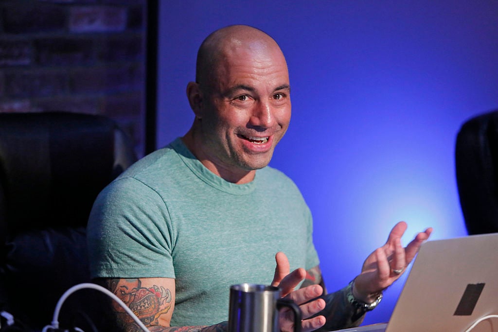 Joe Rogan sitting in front of a laptop