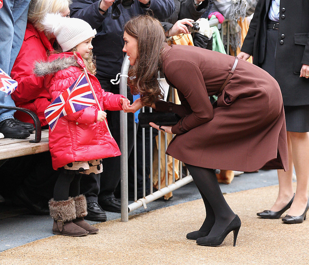 Kate Middleton meets a young girl in Liverpool, England, on Feb. 14, 2012