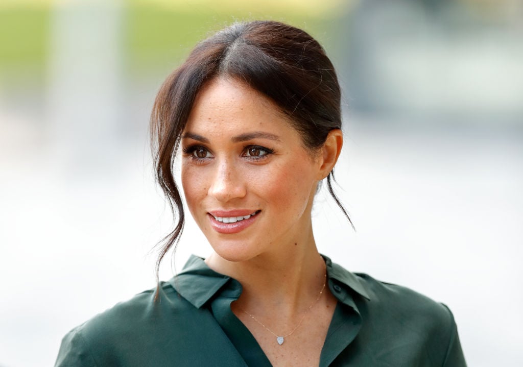 Meghan Markle smiling, looking off camera