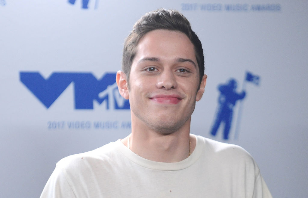 Pete Davidson smiling in front of white background