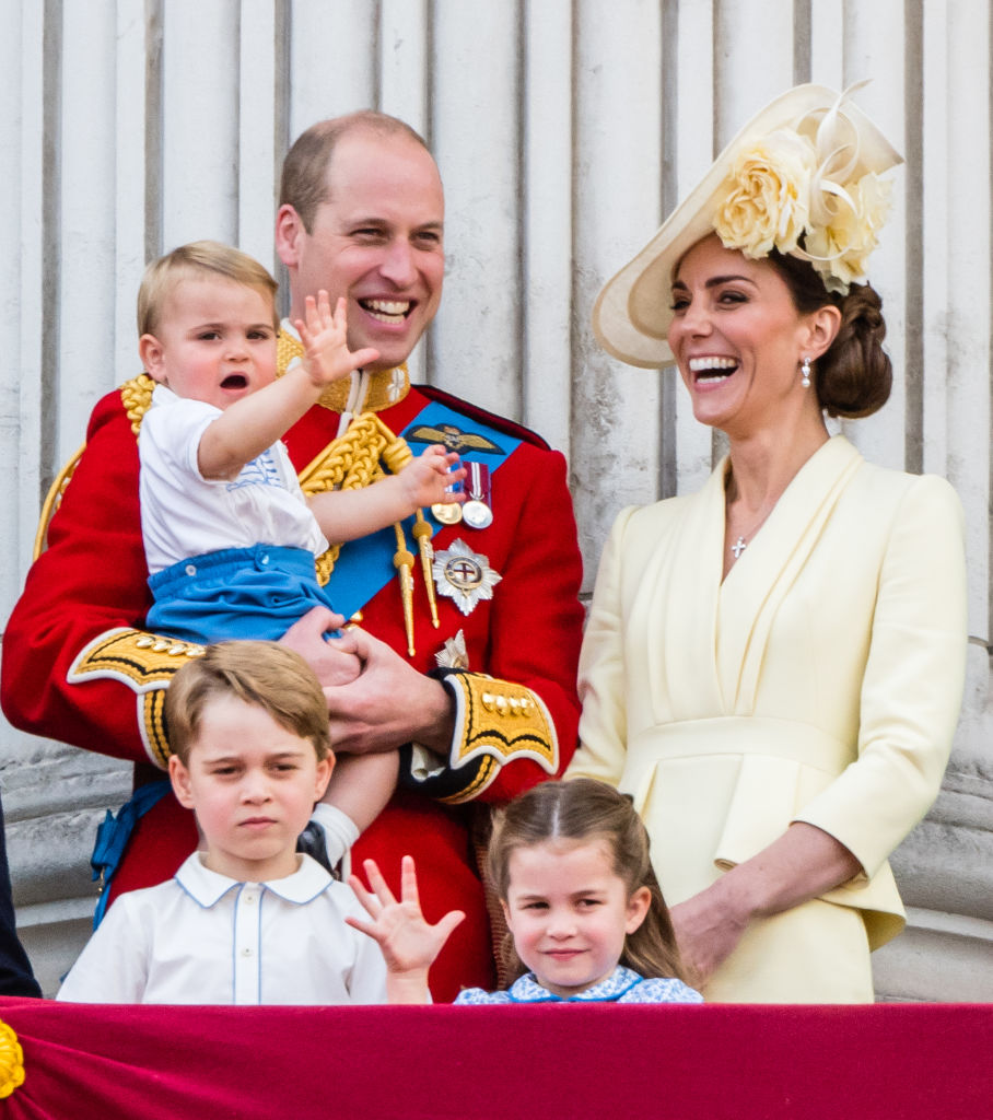 Prince William holds Prince Louis whiie standing next to Kate Middleton, Prince George, and Princess Charlotte at Trooping The Colour on June 8, 2019