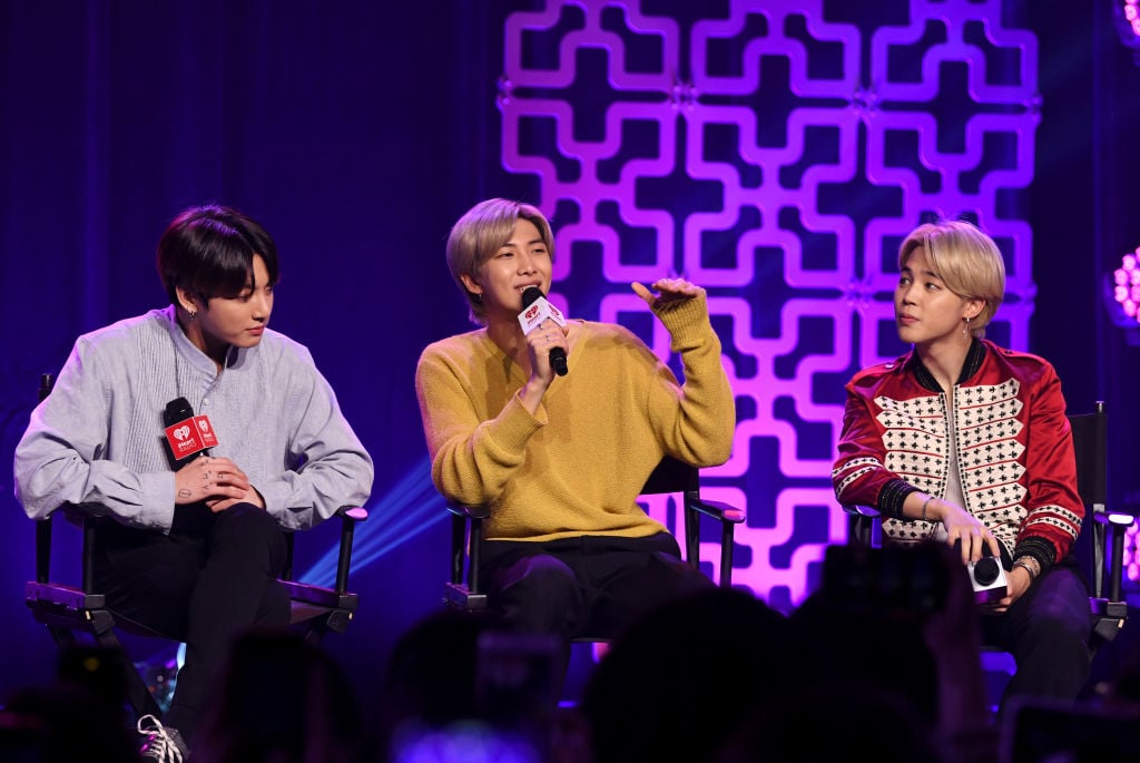 Jungkook, RM, and Jimin of "BTS" speak onstage at iHeartRadio LIVE with BTS 
