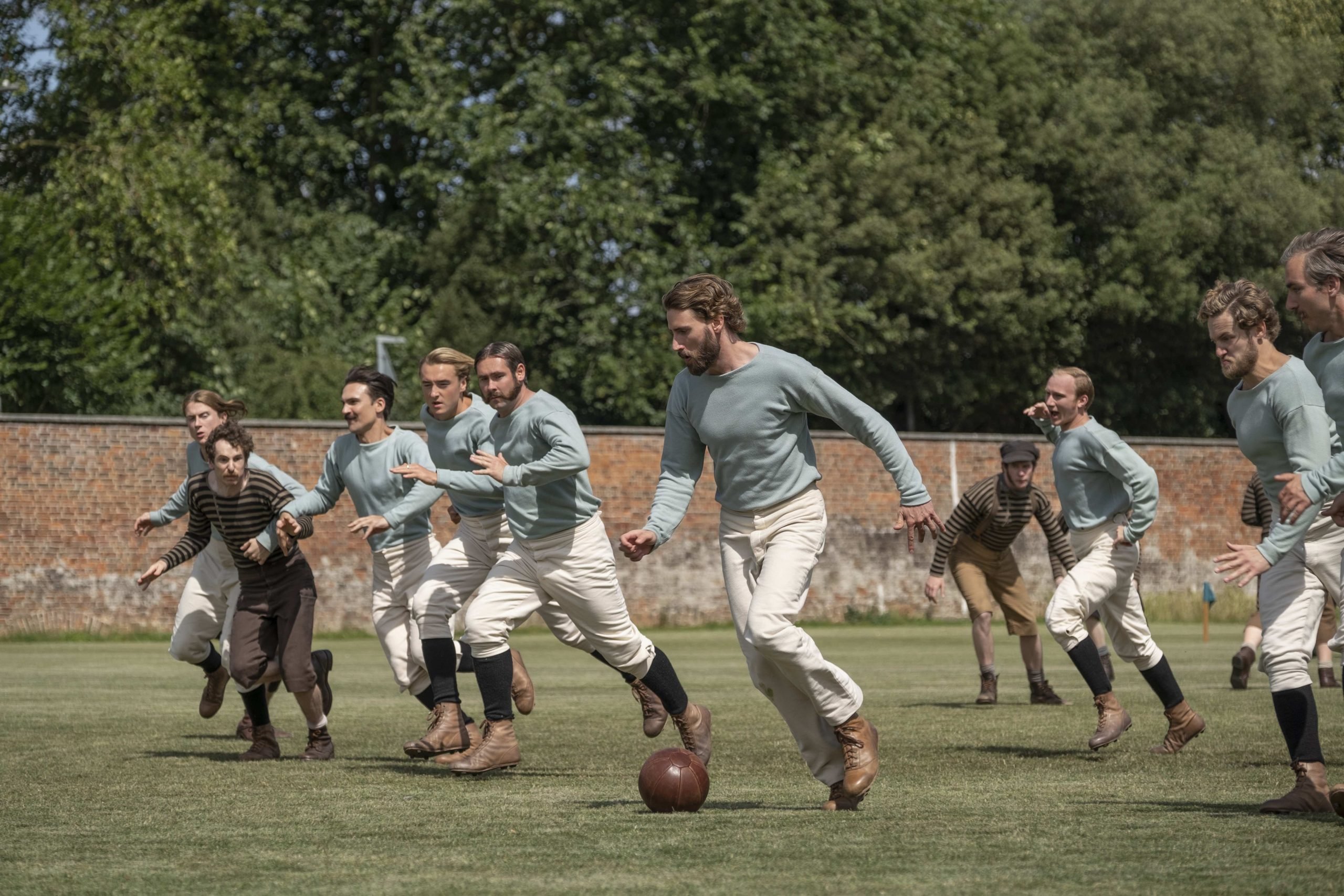 Men playing soccer in 'The English Game' 