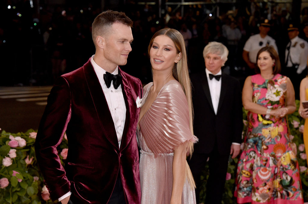 Tom Brady and Gisele Bündchen smiling in formal wear