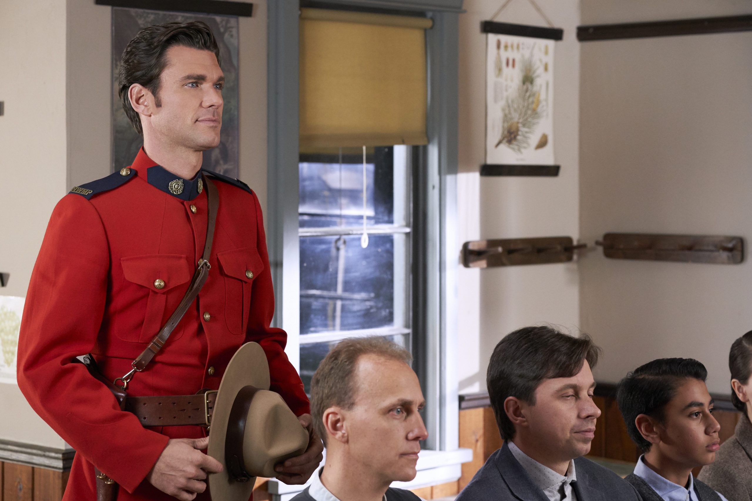 Kevin McGarry as Nathan, wearing red jacket and holding his hat, in 'When Calls the Heart' 